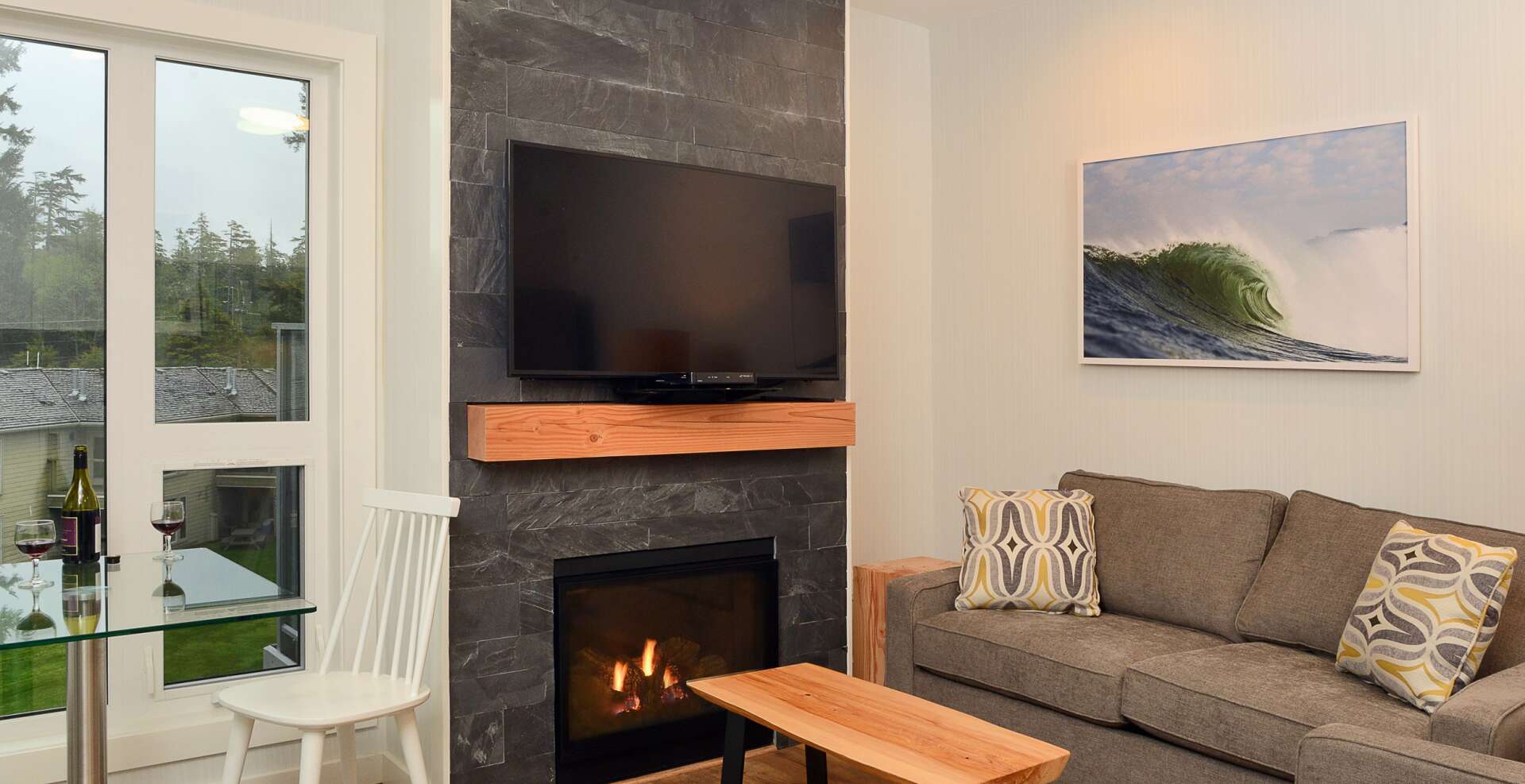 Living room with gas fireplace and dining table for two.