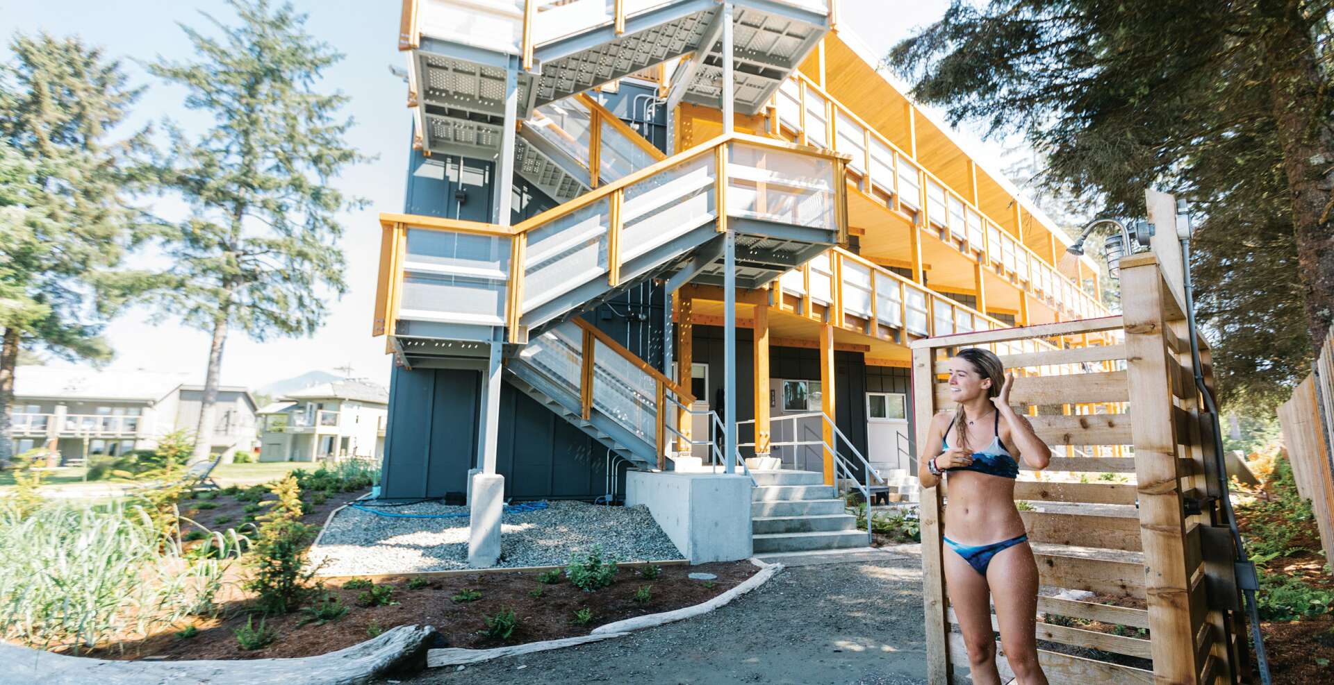 Girl showering after surfing.